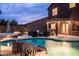Beautiful backyard showcasing a pool with rock features and a comfortable seating area under a charming, covered patio at 3488 N Lady Lake Ln, Casa Grande, AZ 85122