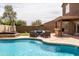 Well-appointed backyard with hot tub, in-ground pool, and comfortable outdoor seating area at 3488 N Lady Lake Ln, Casa Grande, AZ 85122