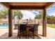 Outdoor entertainment area with swim up bar overlooking a sparkling pool and landscaped backyard at 3488 N Lady Lake Ln, Casa Grande, AZ 85122