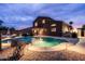 Beautiful backyard with a shimmering pool, an outdoor spa, and a covered patio perfect for entertaining guests at 3488 N Lady Lake Ln, Casa Grande, AZ 85122