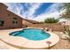 Private backyard with pool featuring a rock waterfall, desert landscaping, and easy access to the home at 3488 N Lady Lake Ln, Casa Grande, AZ 85122