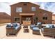 This backyard patio offers a cozy seating area and a built-in bar for outdoor entertaining at 3488 N Lady Lake Ln, Casa Grande, AZ 85122