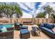 Relax in this backyard oasis, featuring a pool, spa, and comfortable outdoor seating at 3488 N Lady Lake Ln, Casa Grande, AZ 85122