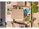 Aerial view of a backyard featuring a pool, putting green, and patio furniture at 3488 N Lady Lake Ln, Casa Grande, AZ 85122