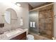 Stylish bathroom featuring a granite countertop vanity and a shower with glass door and tiled walls at 3488 N Lady Lake Ln, Casa Grande, AZ 85122