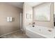 Relaxing bathroom featuring a soaking tub, shower, and a large window for natural light at 3488 N Lady Lake Ln, Casa Grande, AZ 85122