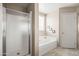 Bathroom featuring a corner soaking tub and a glass enclosed shower at 3488 N Lady Lake Ln, Casa Grande, AZ 85122