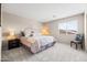 Comfortable bedroom featuring a queen bed, two side tables, and a bright window at 3488 N Lady Lake Ln, Casa Grande, AZ 85122