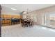 Open-concept dining area next to kitchen, features a vaulted ceiling, skylight, and French doors at 3488 N Lady Lake Ln, Casa Grande, AZ 85122