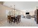 Open-concept dining area boasts a stylish chandelier and seamlessly connects to the spacious living room at 3488 N Lady Lake Ln, Casa Grande, AZ 85122