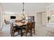 Bright dining area featuring a wooden table with seating for six and stylish chandelier at 3488 N Lady Lake Ln, Casa Grande, AZ 85122