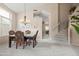 Elegant dining area with a chandelier, staircase access, and space for gathering offers sophisticated charm at 3488 N Lady Lake Ln, Casa Grande, AZ 85122