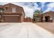 View of the driveway leading to the two car garage, with a side gate and another house to the right at 3488 N Lady Lake Ln, Casa Grande, AZ 85122