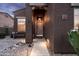 Inviting front entryway with warm lighting and a cozy bench, creating a welcoming first impression at 3488 N Lady Lake Ln, Casa Grande, AZ 85122