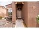 Inviting front entrance featuring a covered porch, desert landscaping, and a charming exterior bench at 3488 N Lady Lake Ln, Casa Grande, AZ 85122