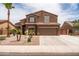Charming two-story home with a well-maintained desert landscaped front yard and a two car garage at 3488 N Lady Lake Ln, Casa Grande, AZ 85122
