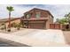 View of a two-story home, driveway, desert landscaping and gate on the side of the house at 3488 N Lady Lake Ln, Casa Grande, AZ 85122
