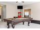 Well-lit game room with a pool table, leather bench, and open layout at 3488 N Lady Lake Ln, Casa Grande, AZ 85122