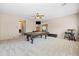 Large game room featuring a pool table, bar stools, popcorn machine, and neutral decor at 3488 N Lady Lake Ln, Casa Grande, AZ 85122
