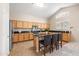 Open kitchen with stainless steel appliances, granite countertops, and a central island with bar seating at 3488 N Lady Lake Ln, Casa Grande, AZ 85122