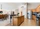 Stylish kitchen featuring granite countertops, stainless steel appliances, and an island with bar seating at 3488 N Lady Lake Ln, Casa Grande, AZ 85122