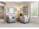 Cozy living room with armchairs, decorative art, and abundant natural light from the window at 3488 N Lady Lake Ln, Casa Grande, AZ 85122