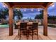 Outdoor bar area perfect for entertaining, with a tiled bar and backyard pool view at 3488 N Lady Lake Ln, Casa Grande, AZ 85122