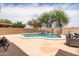 Beautiful backyard featuring a sparkling pool, waterfall feature, lush landscaping, and patio seating at 3488 N Lady Lake Ln, Casa Grande, AZ 85122