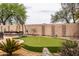 Landscaped backyard with putting green, hot tub, and desert accents at 3488 N Lady Lake Ln, Casa Grande, AZ 85122