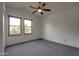 Bright bedroom featuring two windows, ceiling fan, and neutral carpeting at 4017 W Irma Ln, Glendale, AZ 85308