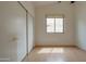 Minimalist bedroom with wood floors, a window, and closet with sliding doors at 4017 W Irma Ln, Glendale, AZ 85308