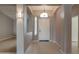 Welcoming foyer with neutral tile flooring, arched doorways, and transom window above the front door at 4017 W Irma Ln, Glendale, AZ 85308