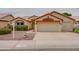Inviting home with a two-car garage, low maintenance yard, and decorative architectural details at 4017 W Irma Ln, Glendale, AZ 85308
