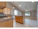 Open kitchen with island, granite countertops, oak cabinets, and stainless appliances at 4017 W Irma Ln, Glendale, AZ 85308