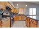 Kitchen featuring stainless steel appliances, granite countertops and oak cabinetry at 4017 W Irma Ln, Glendale, AZ 85308