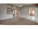 Spacious living area featuring a ceiling fan, neutral paint, tile flooring, and decorative architectural details at 4017 W Irma Ln, Glendale, AZ 85308