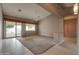 Spacious living room with high ceilings, decorative columns, tile flooring, and sliding glass doors to backyard at 4017 W Irma Ln, Glendale, AZ 85308