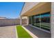 A spacious backyard includes an area of artificial turf and a covered patio, great for relaxing at 4467 S 116Th Ln, Avondale, AZ 85323