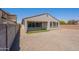 A gravel backyard features synthetic grass and a patio, with the house in the background at 4467 S 116Th Ln, Avondale, AZ 85323