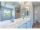 Bright bathroom with double sink vanity, large mirror, and a window allowing for ample natural light at 4467 S 116Th Ln, Avondale, AZ 85323