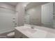 Bright bathroom featuring a shower-tub combination and a single sink vanity with a large mirror at 4467 S 116Th Ln, Avondale, AZ 85323