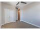 Well-lit bedroom featuring carpeted floors and a fan for comfort with a standard closet at 4467 S 116Th Ln, Avondale, AZ 85323