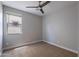 This simple bedroom has a window offering natural light and a ceiling fan to maintain a cool, breezy atmosphere at 4467 S 116Th Ln, Avondale, AZ 85323