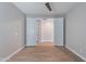 Large bedroom with wood-look tile floors, ceiling fan, and a view into another room through double doors at 4467 S 116Th Ln, Avondale, AZ 85323