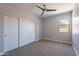 Cozy bedroom with neutral carpet, closet, and a window offering natural light at 4467 S 116Th Ln, Avondale, AZ 85323