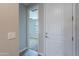 Bright entryway featuring white door and trim, leading to a carpeted bedroom with lots of light at 4467 S 116Th Ln, Avondale, AZ 85323