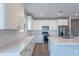Bright kitchen features white cabinets, stainless appliances, and a stylish backsplash, with quartz countertops at 4467 S 116Th Ln, Avondale, AZ 85323