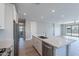 Beautiful kitchen with stainless steel appliances, granite countertop island, and modern light fixtures at 4467 S 116Th Ln, Avondale, AZ 85323