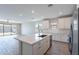 Spacious kitchen with a large center island, stainless steel appliances, and wood-style flooring at 4467 S 116Th Ln, Avondale, AZ 85323