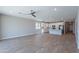 Spacious living area shows the bright kitchen, wood look tile floors, recessed lights, and an open concept layout at 4467 S 116Th Ln, Avondale, AZ 85323